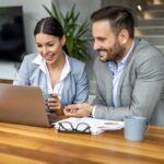 picture of a man and woman dressed in suits, talking or interacting, business mode on